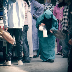 Old woman carrying a bottle of milk in a moroccan market 