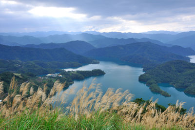 Scenic view of lake and mountains against sky