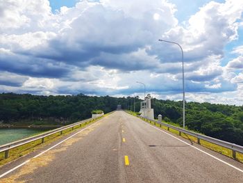 Road by street against sky