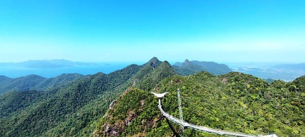 Scenic view of mountains against clear blue sky