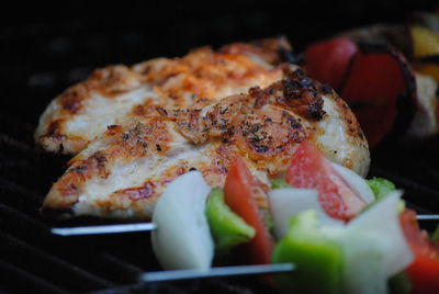 Close-up of meat and vegetable skewers on barbecue