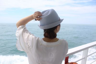 Rear view of woman traveling on boat in sea