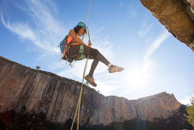 Young woman abseiling on chulilla canyon (spain)