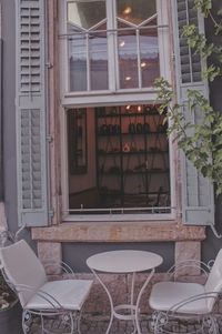 Empty chairs and tables in front of building