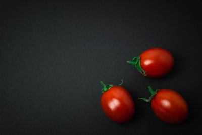 Close-up of cherry tomatoes against black background