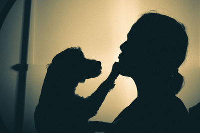 Close-up playing with her dog indoors