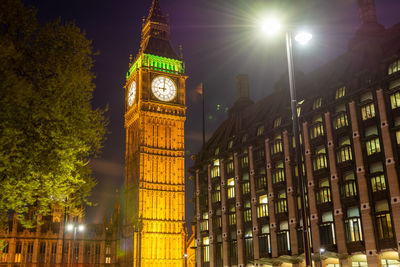 Low angle view of illuminated building against sky at night