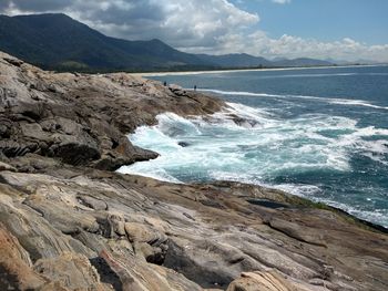 Scenic view of sea and mountains against sky