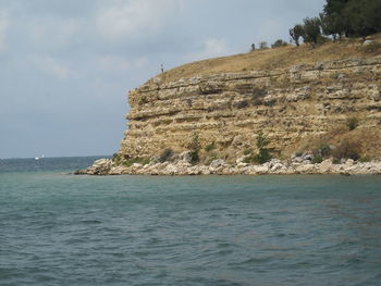 Scenic view of sea and rocks against sky