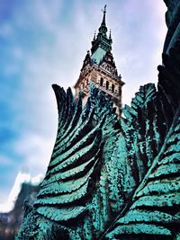 Low angle view of temple against cloudy sky