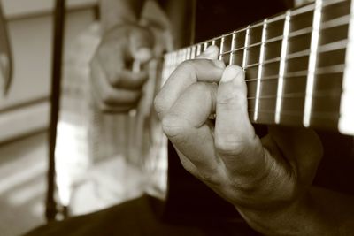 Close-up of man playing guitar