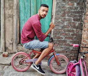 Portrait of young man riding bicycle