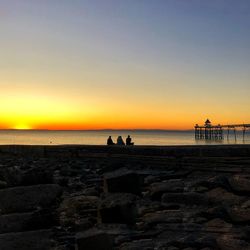 Scenic view of sea against clear sky during sunset