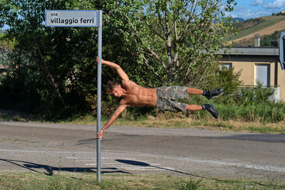 Low angle view of man walking on road