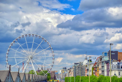 Ferris wheel in city against sky