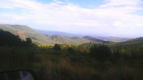 Scenic view of mountains against cloudy sky