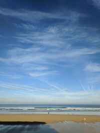 Scenic view of beach against blue sky