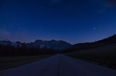 Road against sky at night