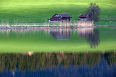 Scenic view of lake by house and building