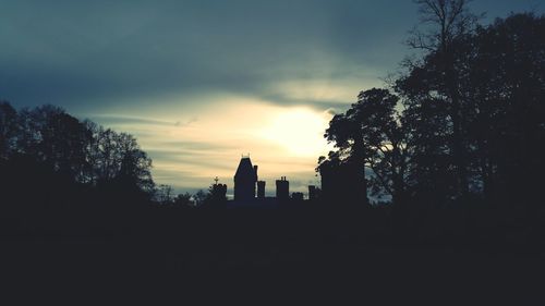 Silhouette of trees against sky at sunset