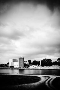 Buildings by road against sky in city