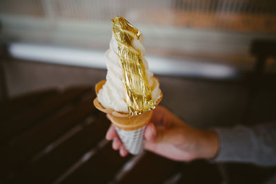 Close-up of hand holding ice cream cone