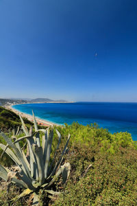 Scenic view of sea against clear blue sky