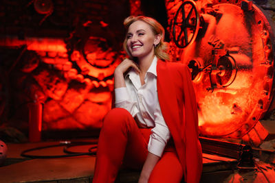 Portrait of young woman sitting on stage