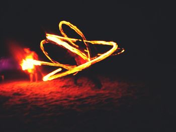 Close-up of illuminated lights over black background