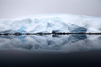 Frozen lake against sky during winter