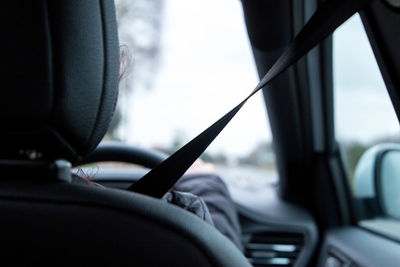 Close-up of person seen through car windshield