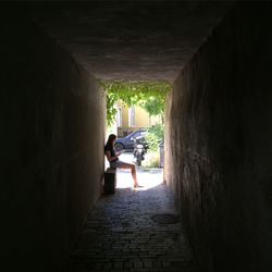 Full length of woman walking in alley