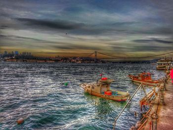 Scenic view of sea against cloudy sky at sunset