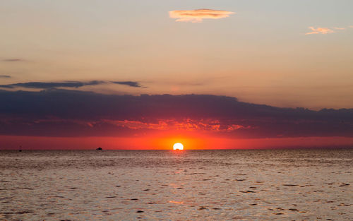 Scenic view of sea against orange sky