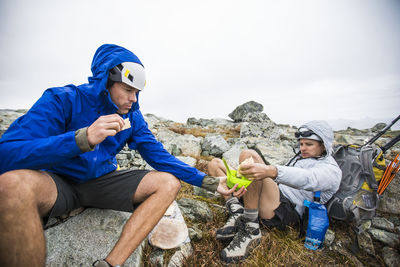 Climbers share food during a backpacking trip.