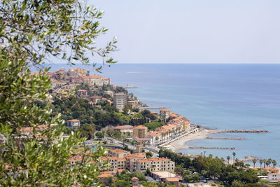 High angle view of townscape by sea against sky