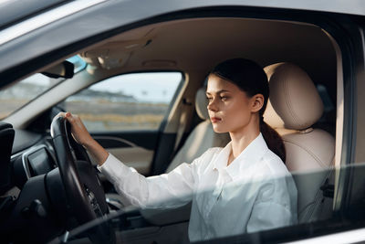 Portrait of smiling woman sitting in car