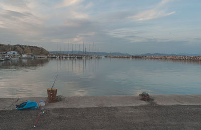 Sailboats moored in lake against sky