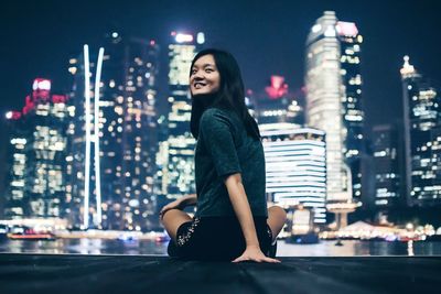 Portrait of woman standing in front of building