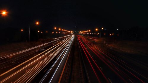 High angle view of light trails on highway at night