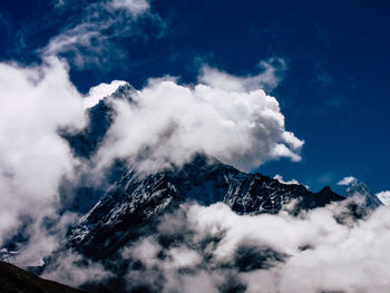 Low angle view of snowcapped mountains against sky