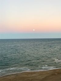 Scenic view of sea against clear sky during sunset