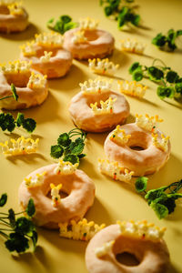 Sugar-glazed doughnuts decorated with artificial bunnies for easter 