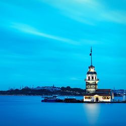 Calm blue sea with buildings in background
