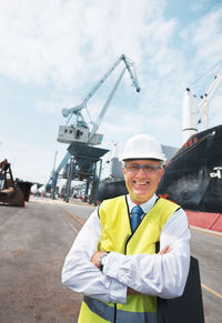 Smiling engineer standing with arms crossed