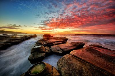 Scenic view of sea against dramatic sky