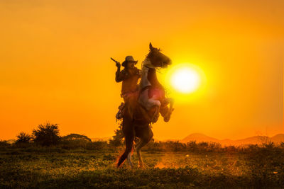 Full length of man on field against sky during sunset