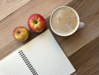 High angle view of apples and coffee on table