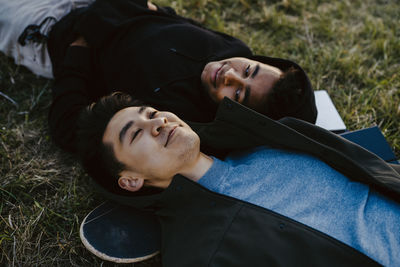 High angle view of male friends lying down