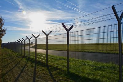 Fence on field against sky